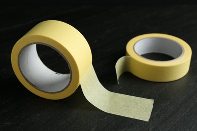 Rolls of masking tape on black table, closeup