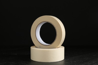 Photo of Rolls of masking tape on black table