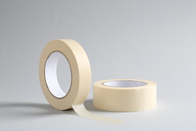 Photo of Two masking tapes on grey background, closeup