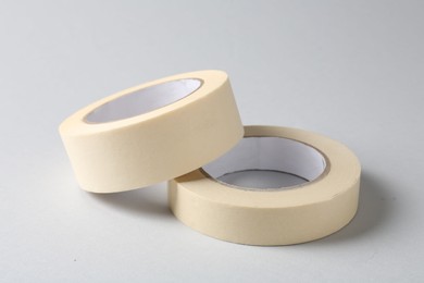 Photo of Two masking tapes on grey background, closeup