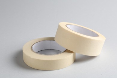 Photo of Two masking tapes on grey background, closeup