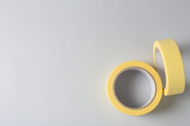 Photo of Two masking tapes on grey background, top view. Space for text