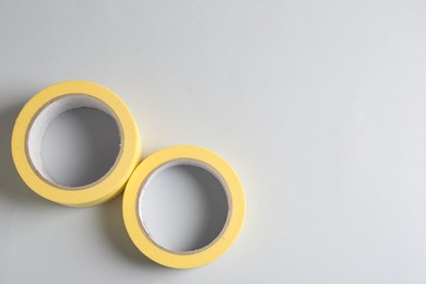 Photo of Two masking tapes on grey background, top view. Space for text