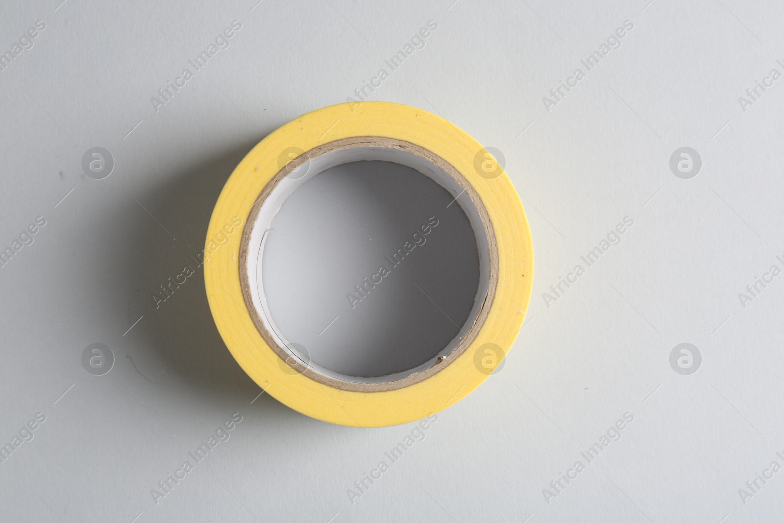 Photo of One masking tape on grey background, top view