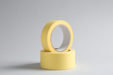 Photo of Two masking tapes on grey background, closeup