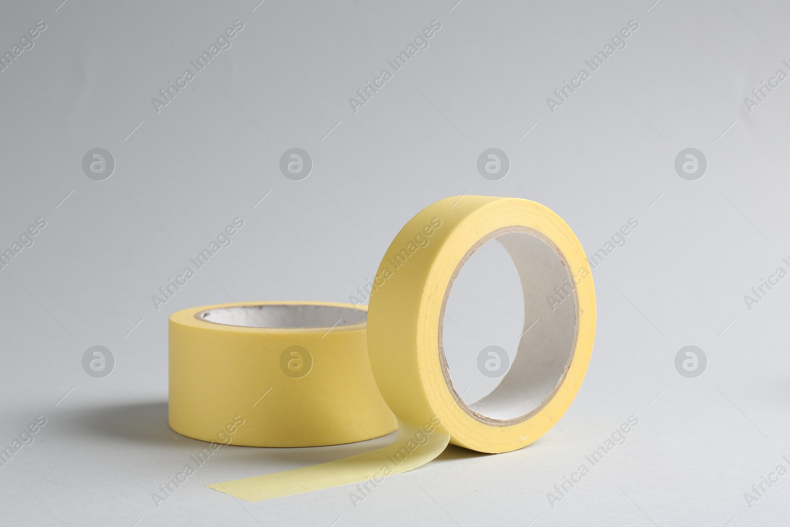 Photo of Two masking tapes on grey background, closeup