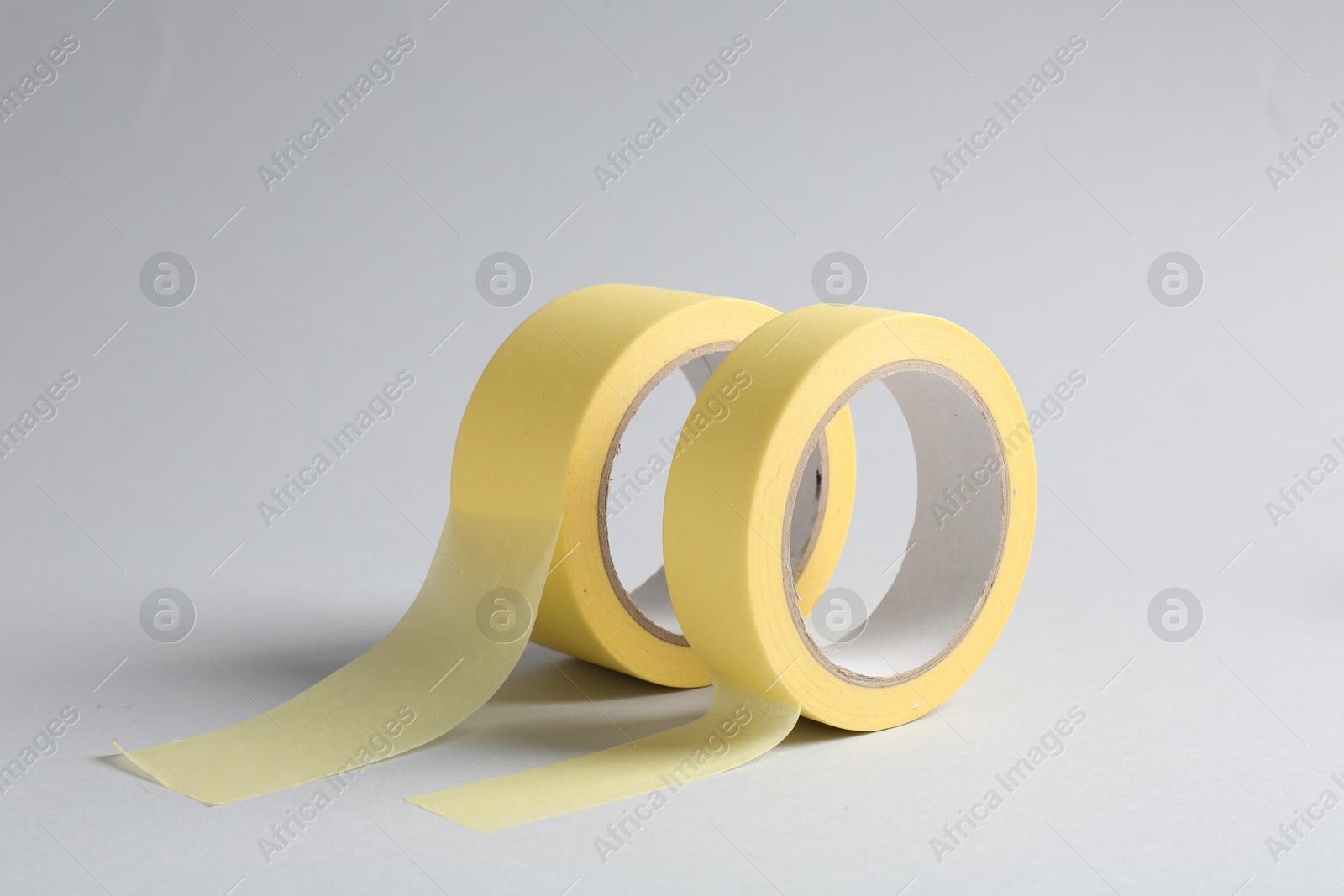 Photo of Two masking tapes on grey background, closeup