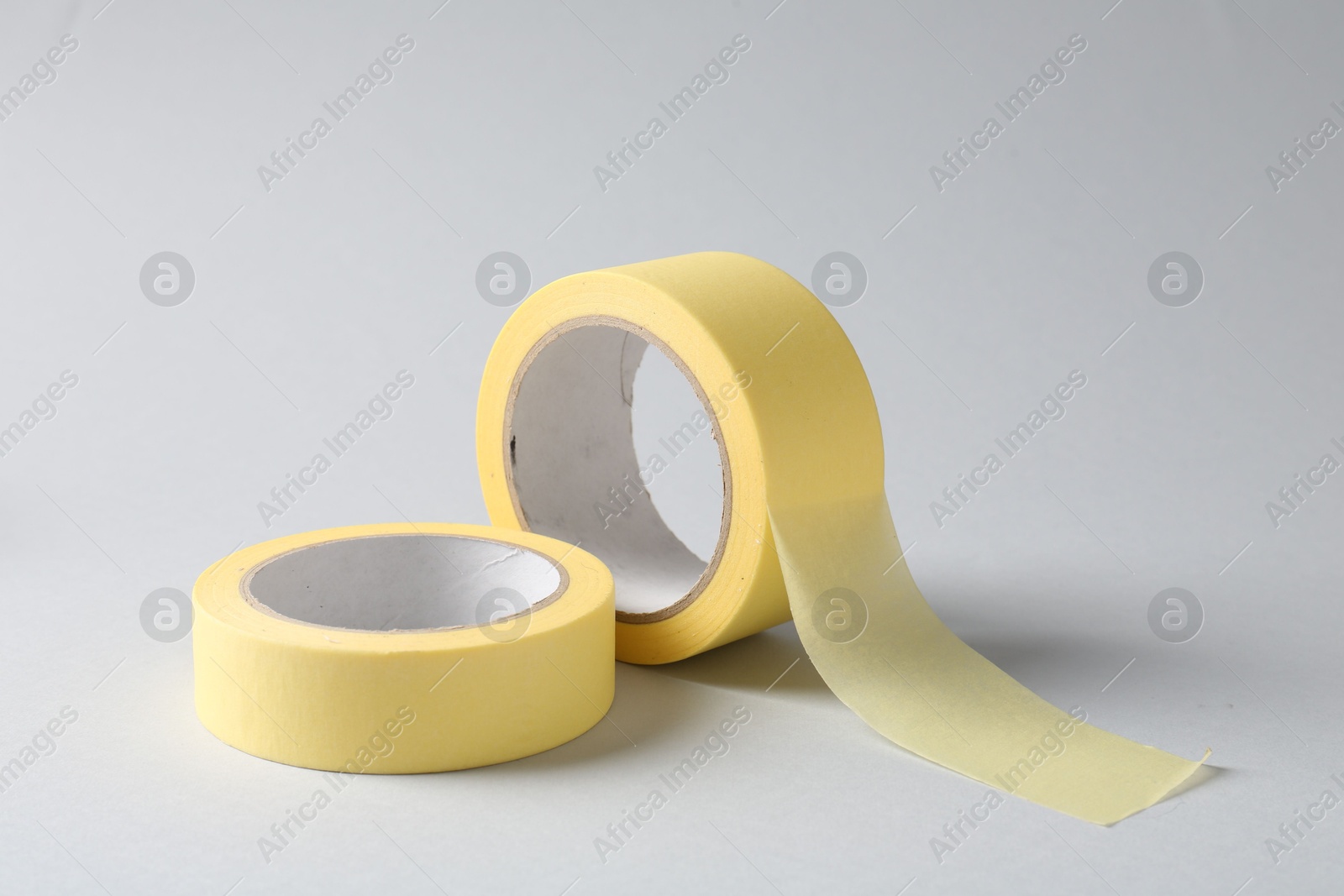 Photo of Two masking tapes on grey background, closeup