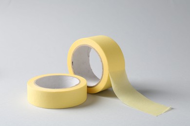 Photo of Two masking tapes on grey background, closeup