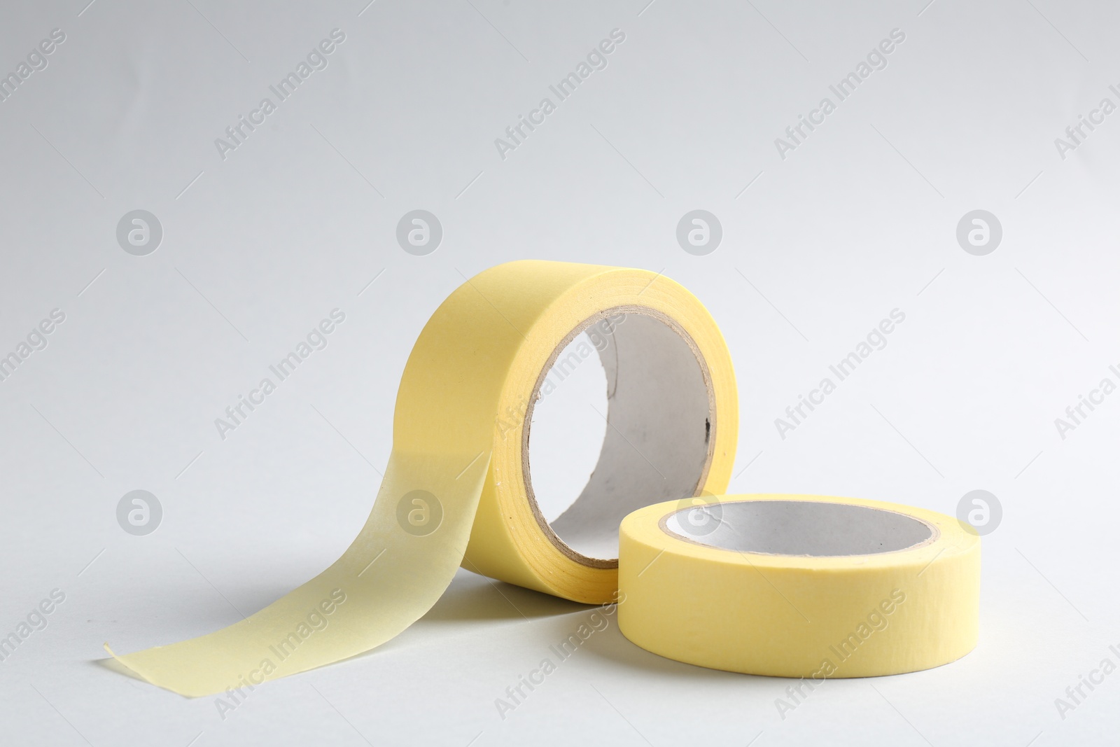 Photo of Two masking tapes on grey background, closeup