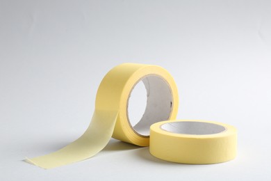 Photo of Two masking tapes on grey background, closeup