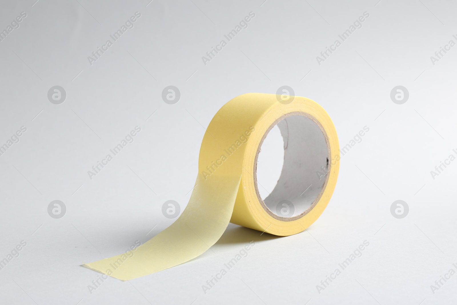 Photo of One masking tape on grey background, closeup