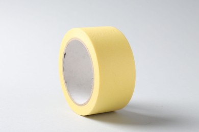 Photo of One masking tape on grey background, closeup