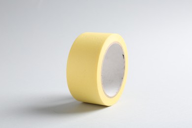 Photo of One masking tape on grey background, closeup