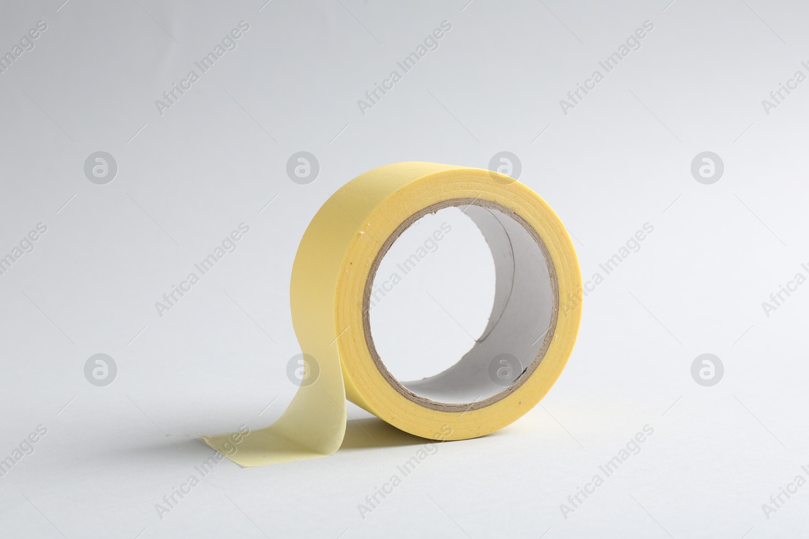 Photo of One masking tape on grey background, closeup