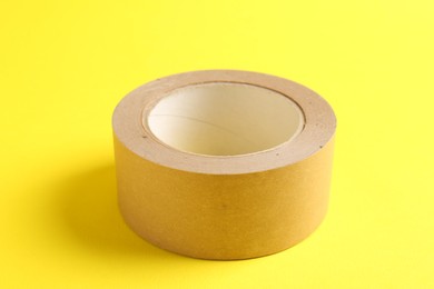 One masking tape on yellow background, closeup