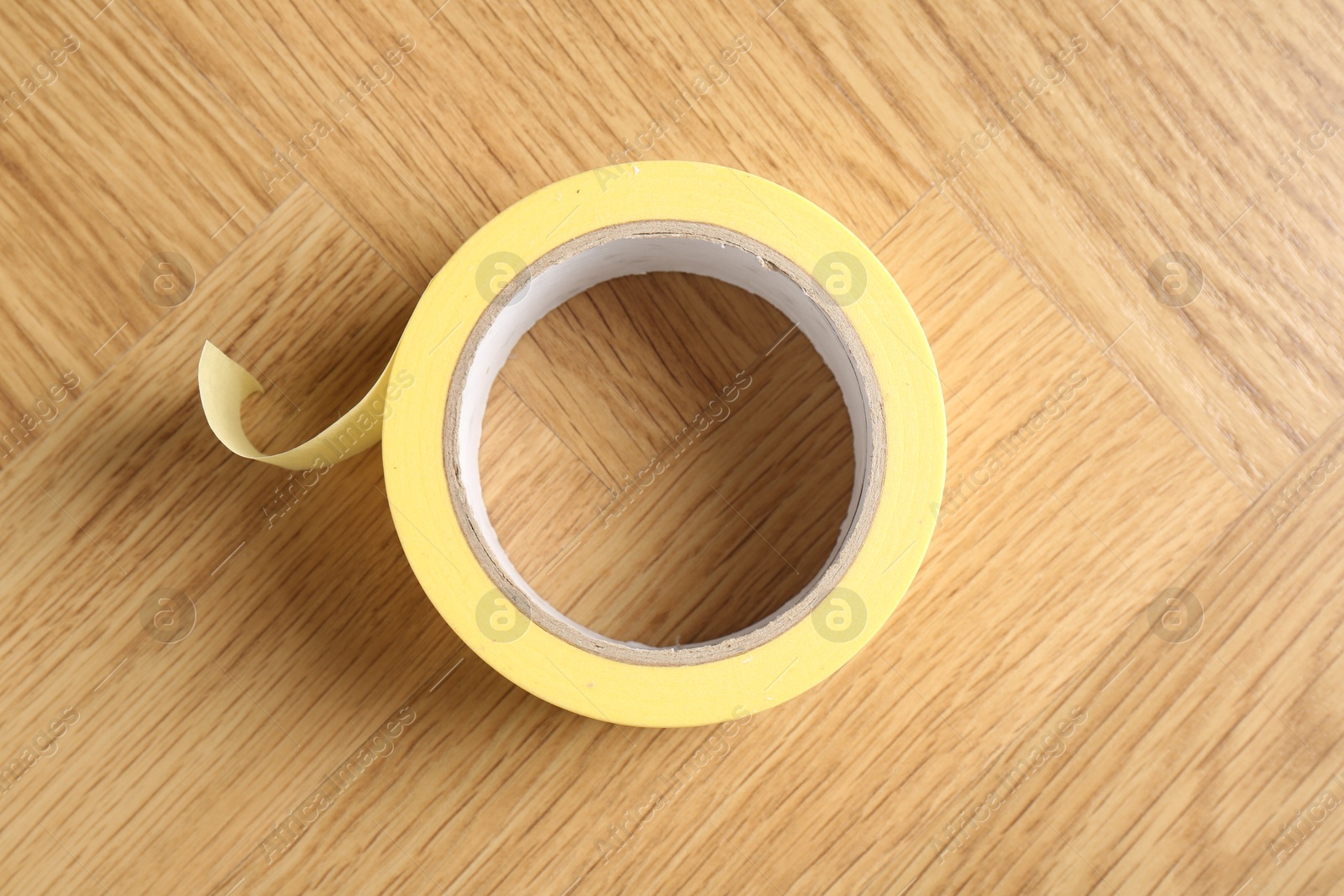 Photo of One masking tape on wooden table, top view