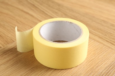 One adhesive tape on wooden table, closeup