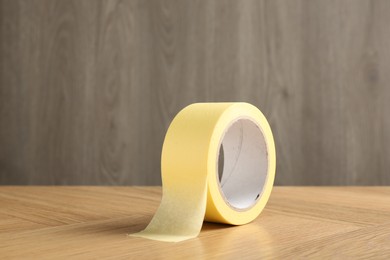 One masking tape on wooden table, closeup