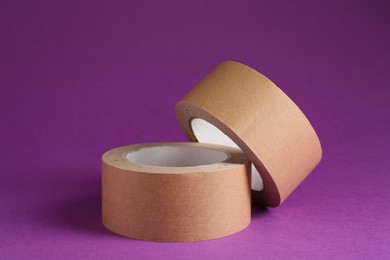 Rolls of masking tapes on violet background