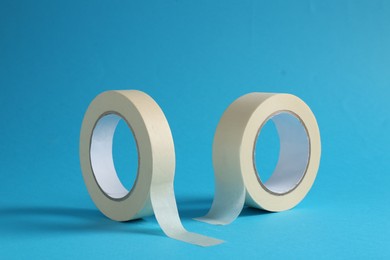 Photo of Rolls of masking tapes on light blue background