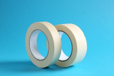 Photo of Rolls of masking tapes on light blue background