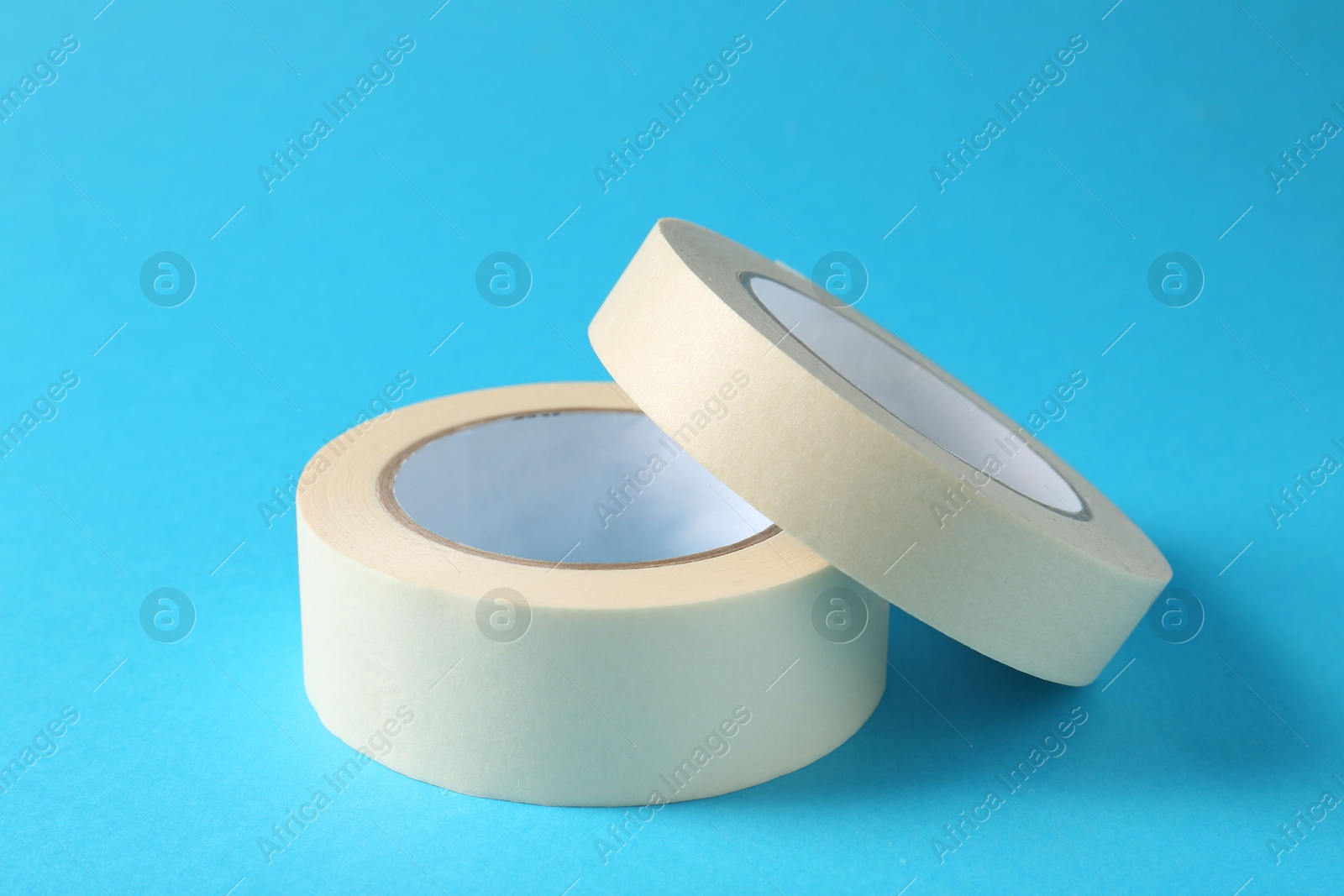 Photo of Rolls of masking tapes on light blue background