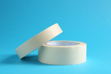 Photo of Rolls of masking tapes on light blue background