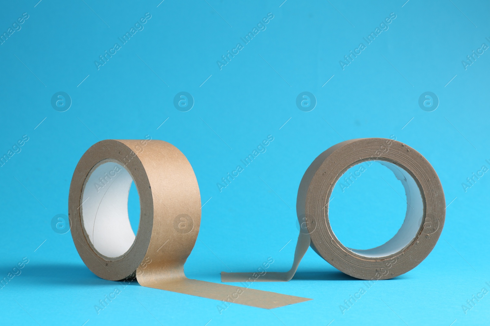 Photo of Rolls of masking tapes on light blue background