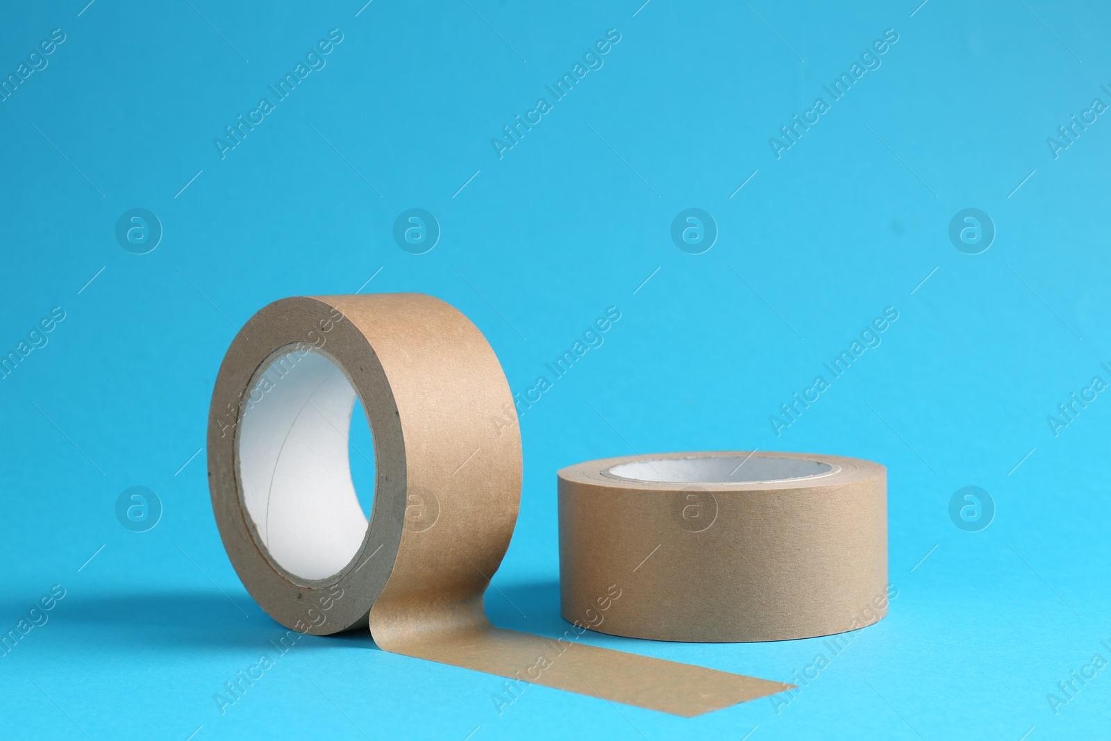 Photo of Rolls of masking tapes on light blue background