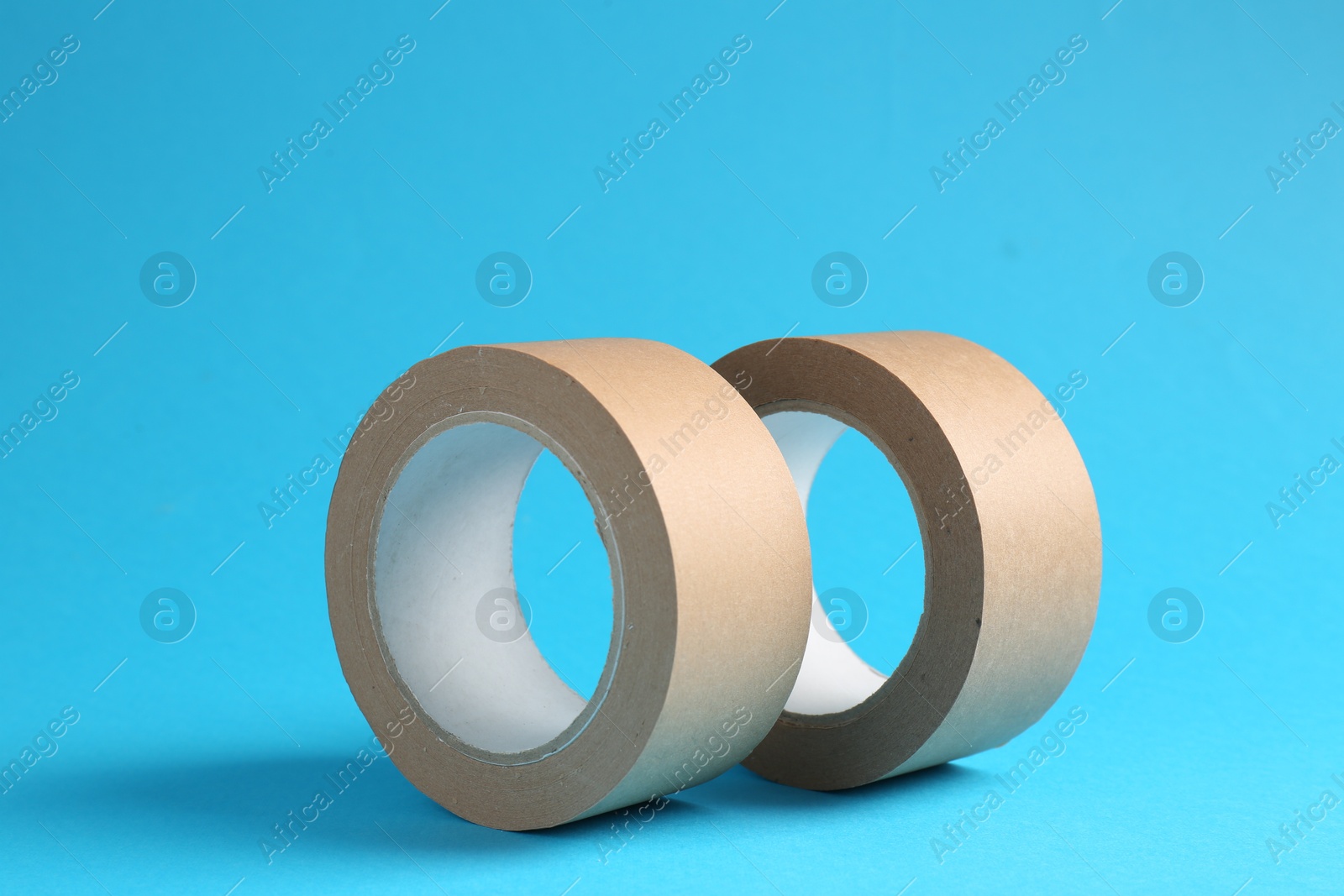 Photo of Rolls of masking tapes on light blue background