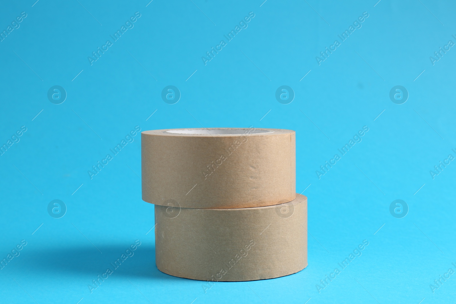 Photo of Rolls of masking tapes on light blue background