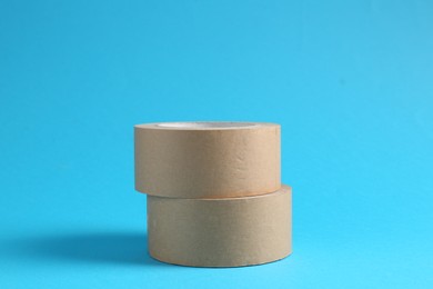 Photo of Rolls of masking tapes on light blue background