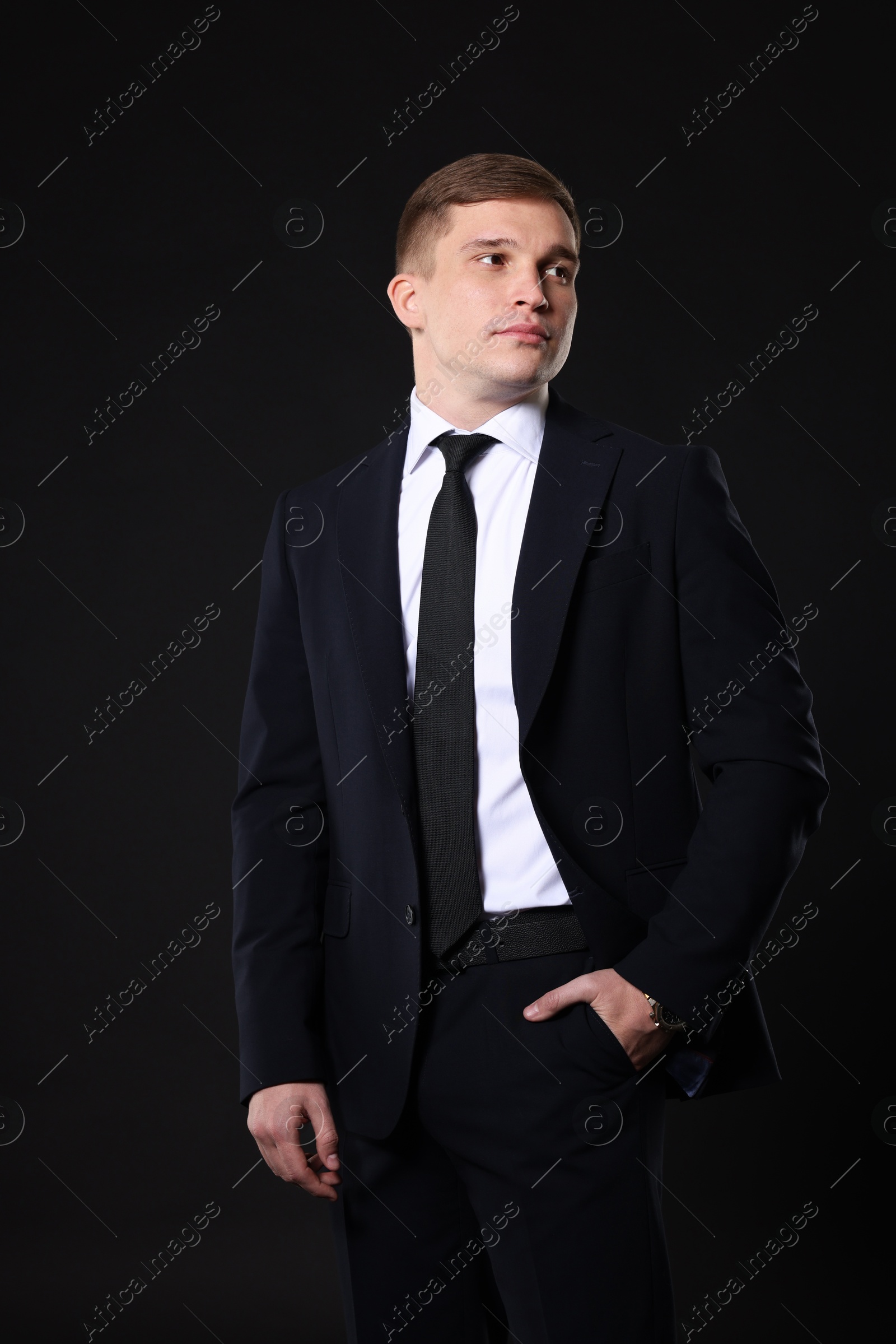 Photo of Man in classic suit on black background