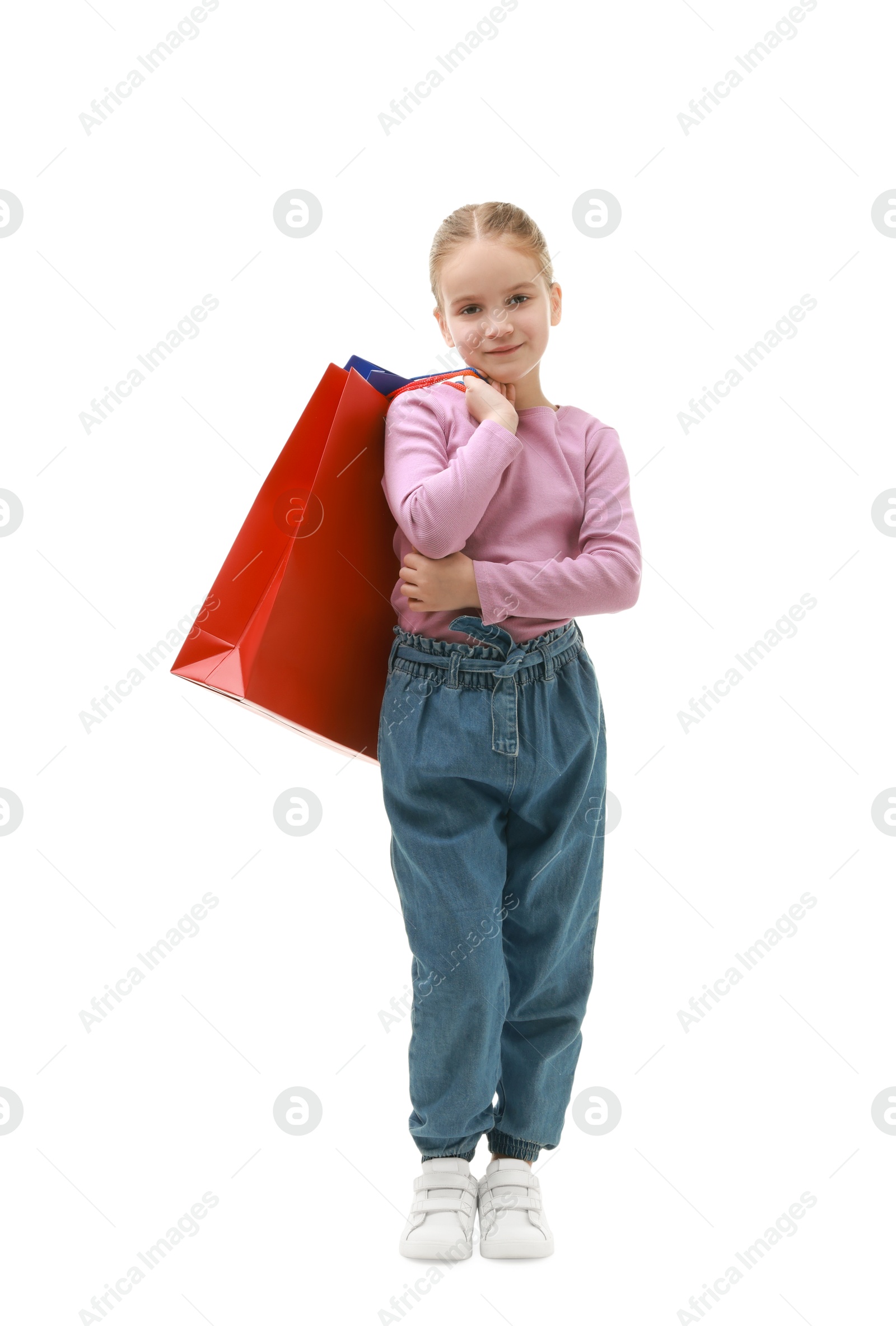 Photo of Cute little girl with shopping bags on white background