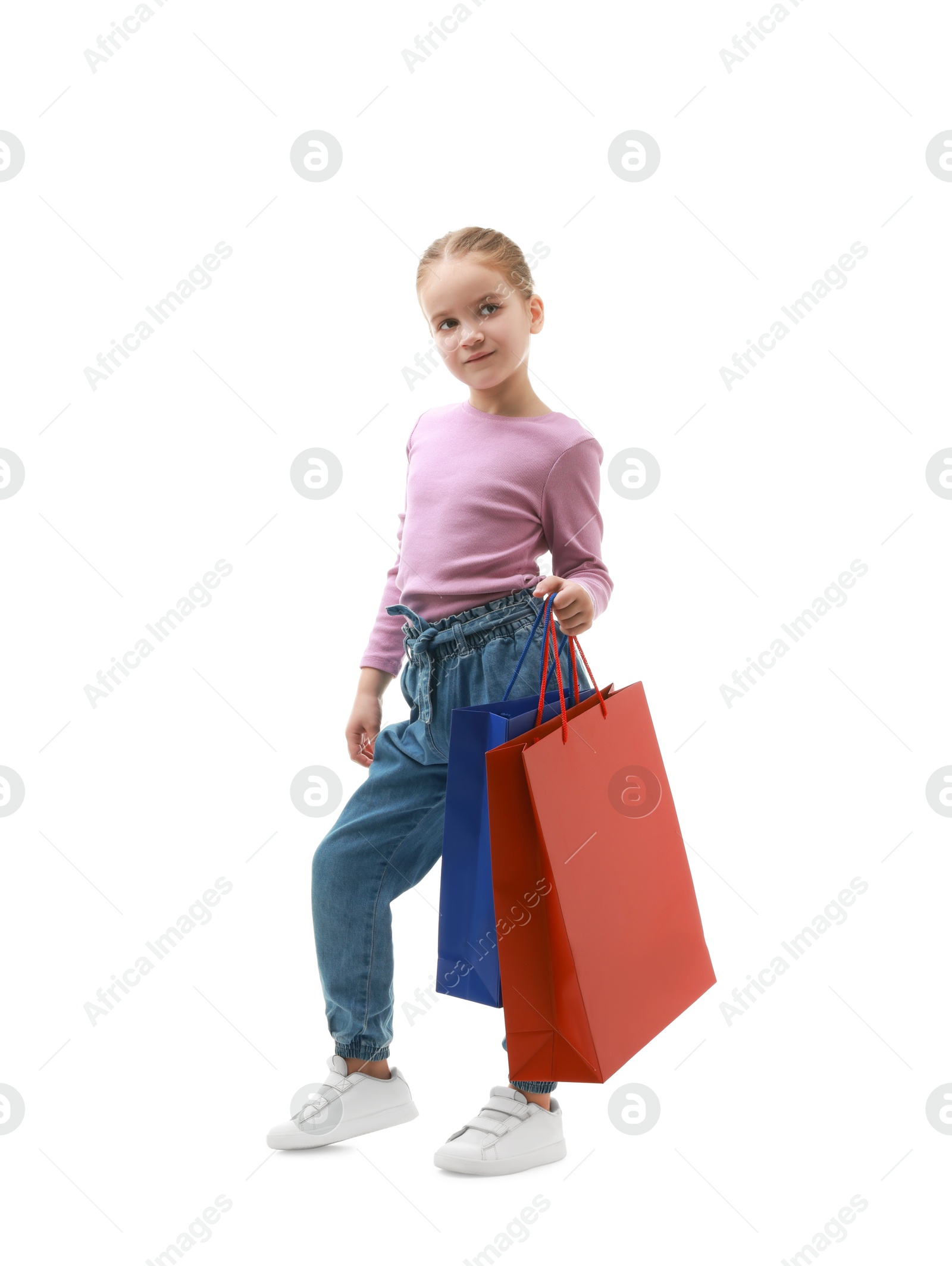 Photo of Cute little girl with shopping bags on white background