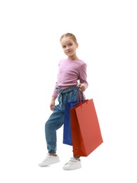 Photo of Cute little girl with shopping bags on white background