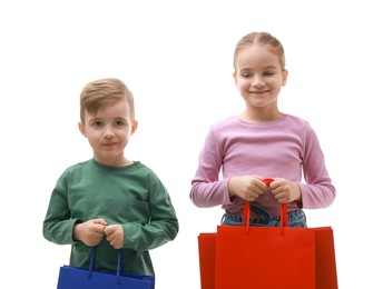 Photo of Cute little friends with shopping bags on white background