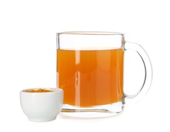 Photo of Aromatic turmeric tea in glass cup and powder isolated on white