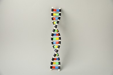 Photo of DNA structure model on light grey background