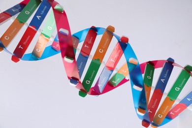 Photo of DNA structure model on light background, closeup