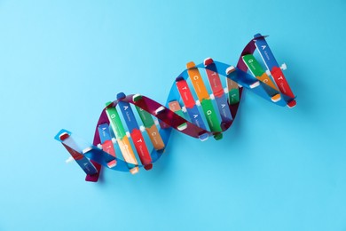 Photo of Colorful DNA structure model on light blue background, top view