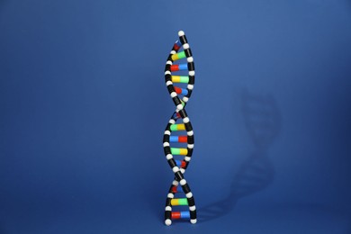 Photo of Colorful DNA structure model on blue background