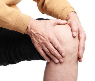 Photo of Senior man suffering from knee pain on white background, closeup