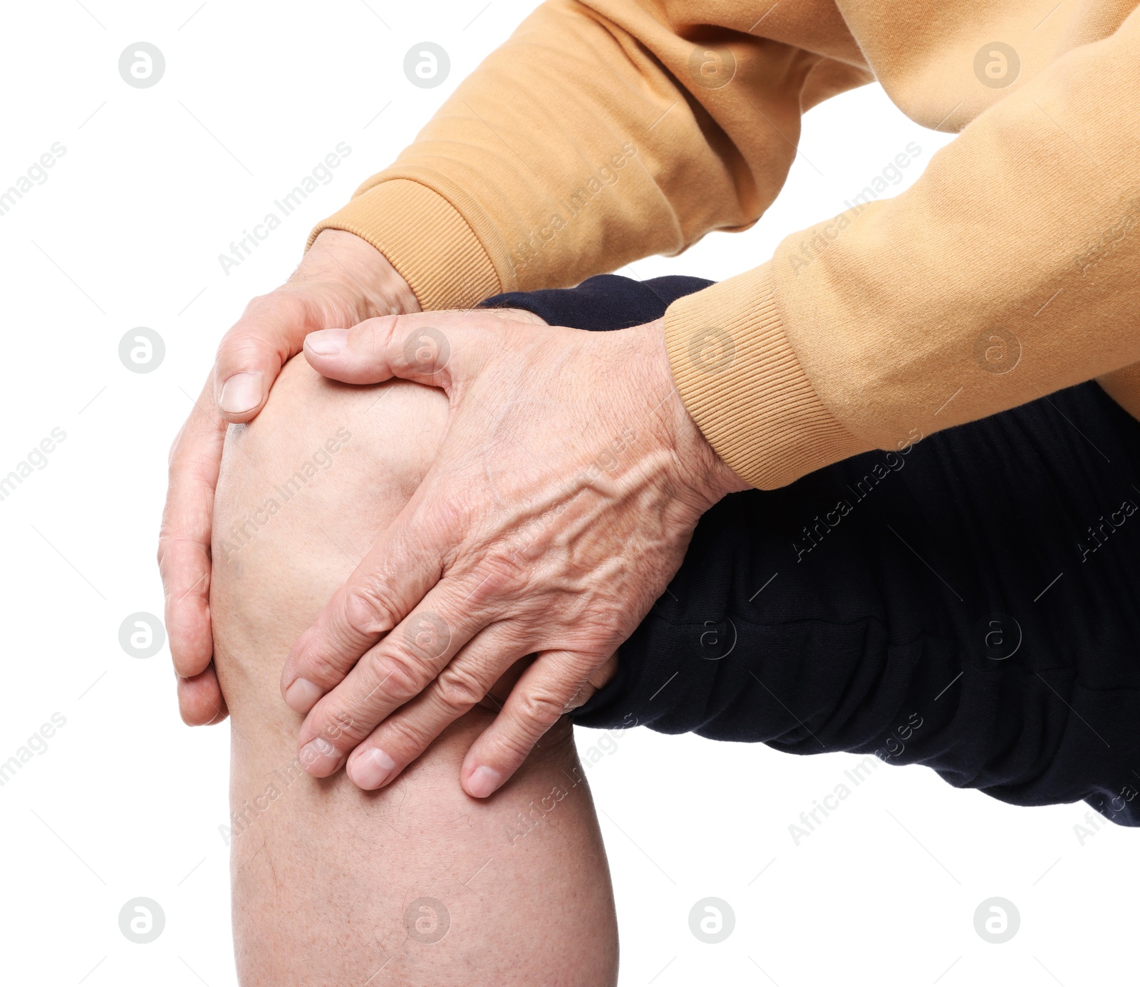 Photo of Senior man suffering from knee pain on white background, closeup