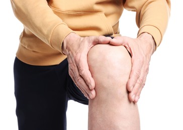 Photo of Senior man suffering from knee pain on white background, closeup