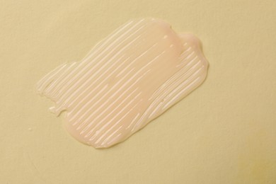 Photo of Sample of cosmetic product on beige background, top view