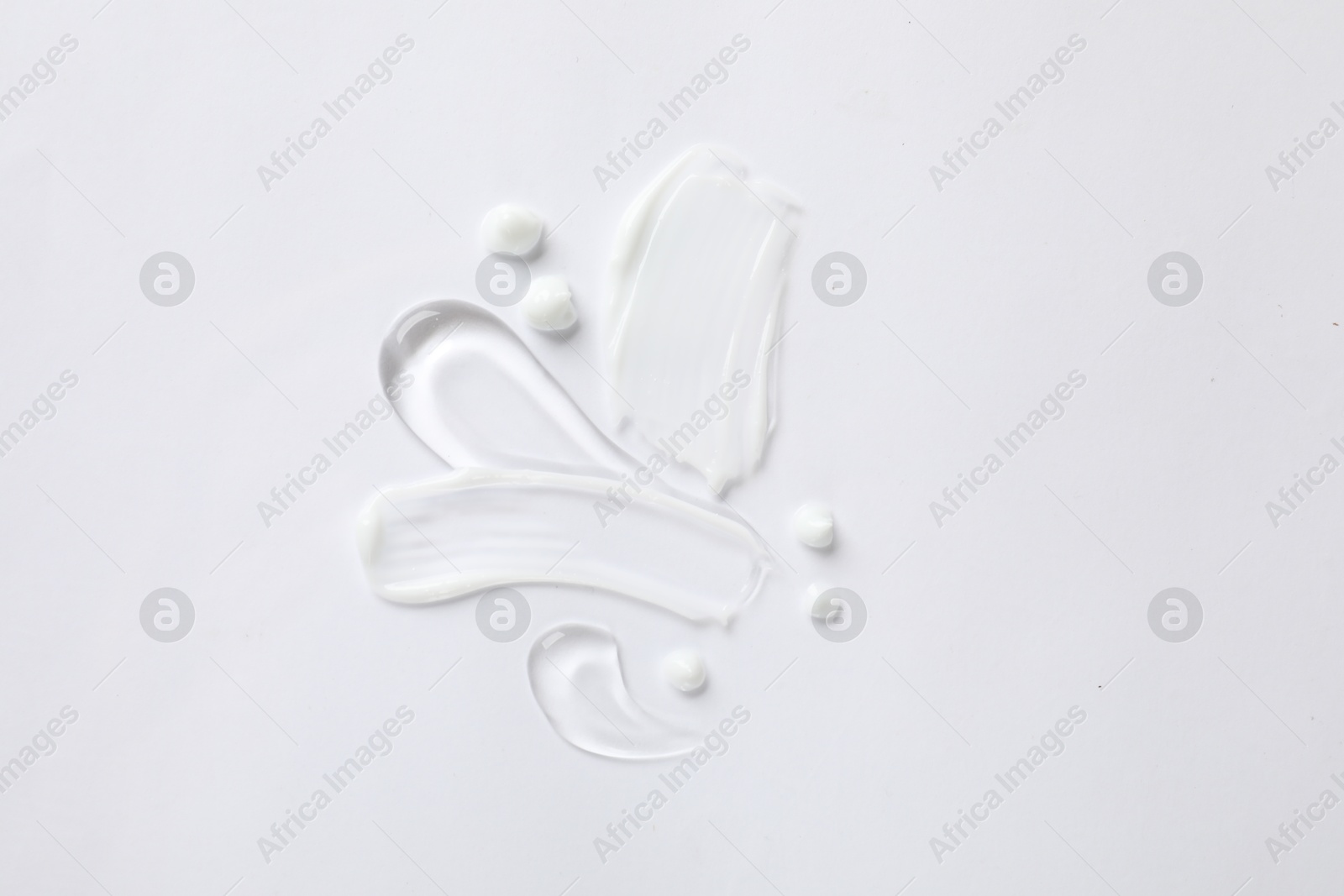 Photo of Samples of different cosmetic products on white background, top view