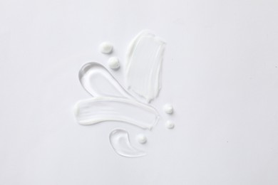 Photo of Samples of different cosmetic products on white background, top view