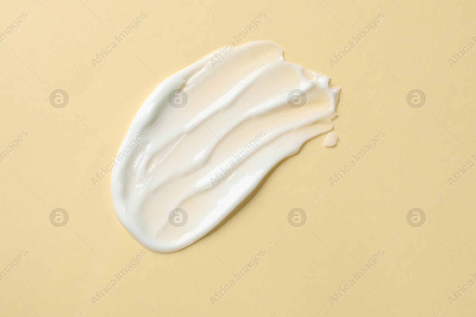 Photo of Sample of body cream on beige background, top view